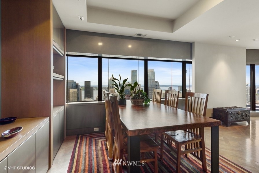 1301 Spring Street, Unit 30J Seattle, WA 98104 - Photo 8 of 40 a view of a dining room with furniture window and wooden floor