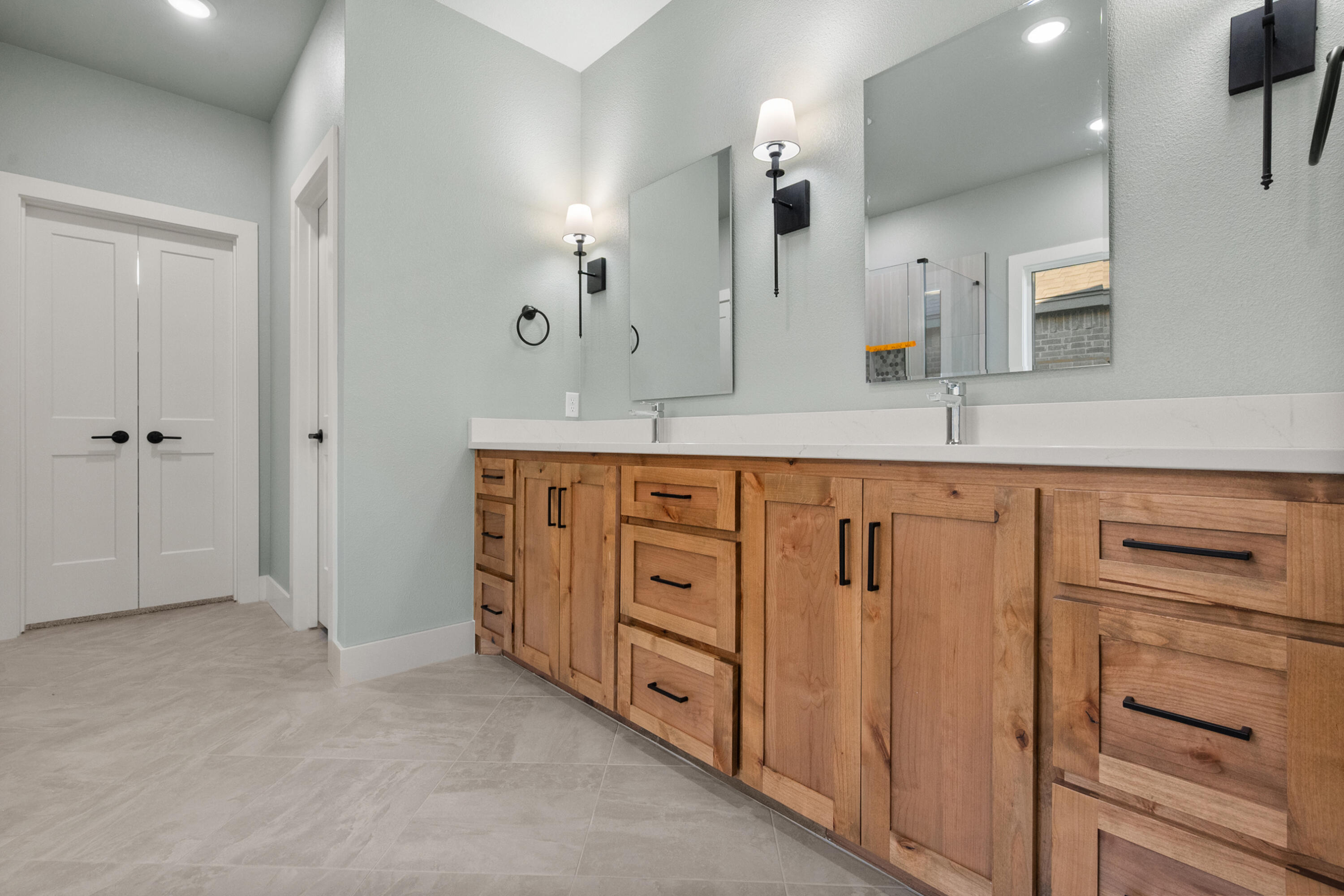 1121 North 6th Street Wolfforth, TX 79382 - Photo 19 of 31 a spacious bathroom with a granite countertop sink two mirror and a