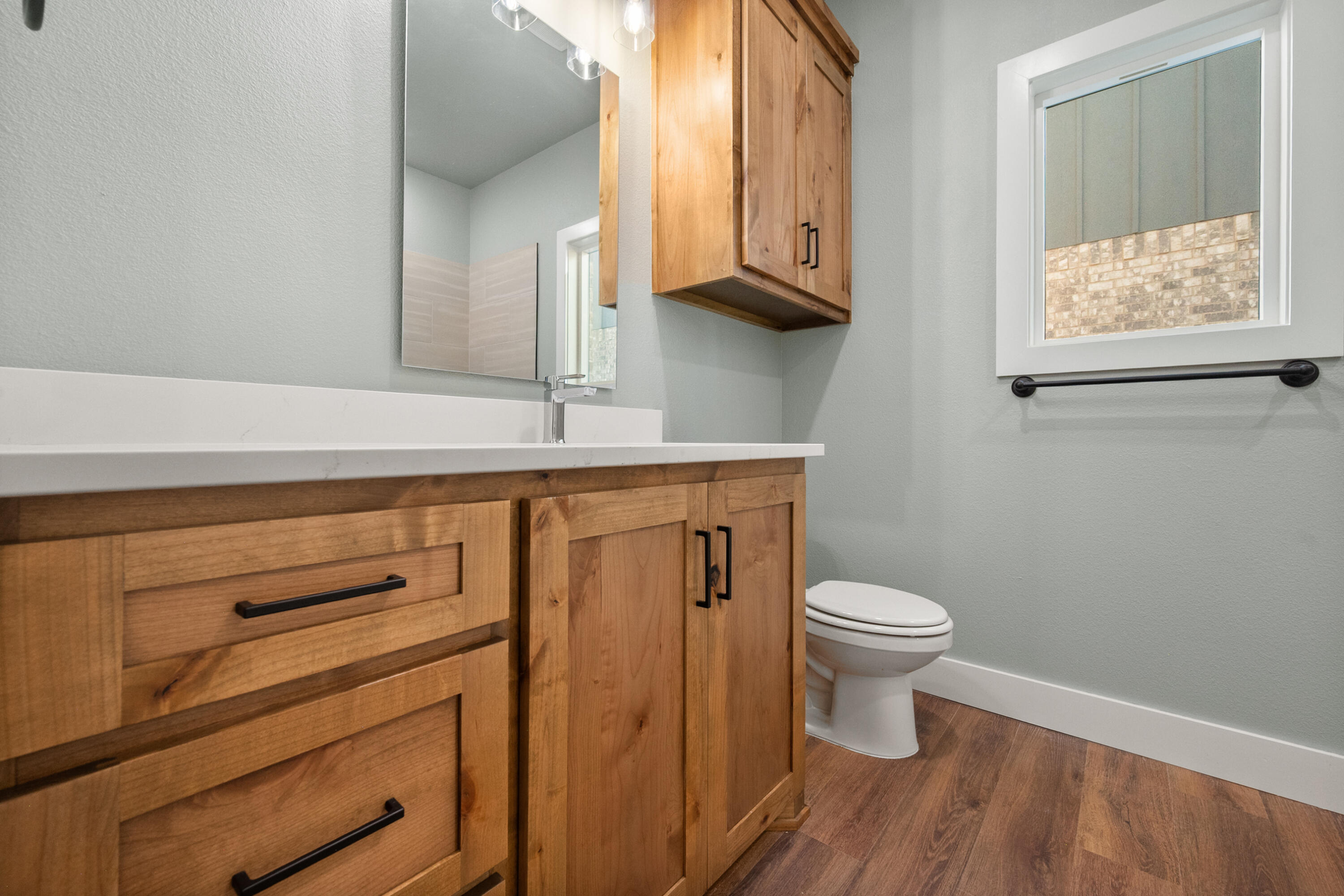 1121 North 6th Street Wolfforth, TX 79382 - Photo 24 of 31 a bathroom with a toilet a sink and a window