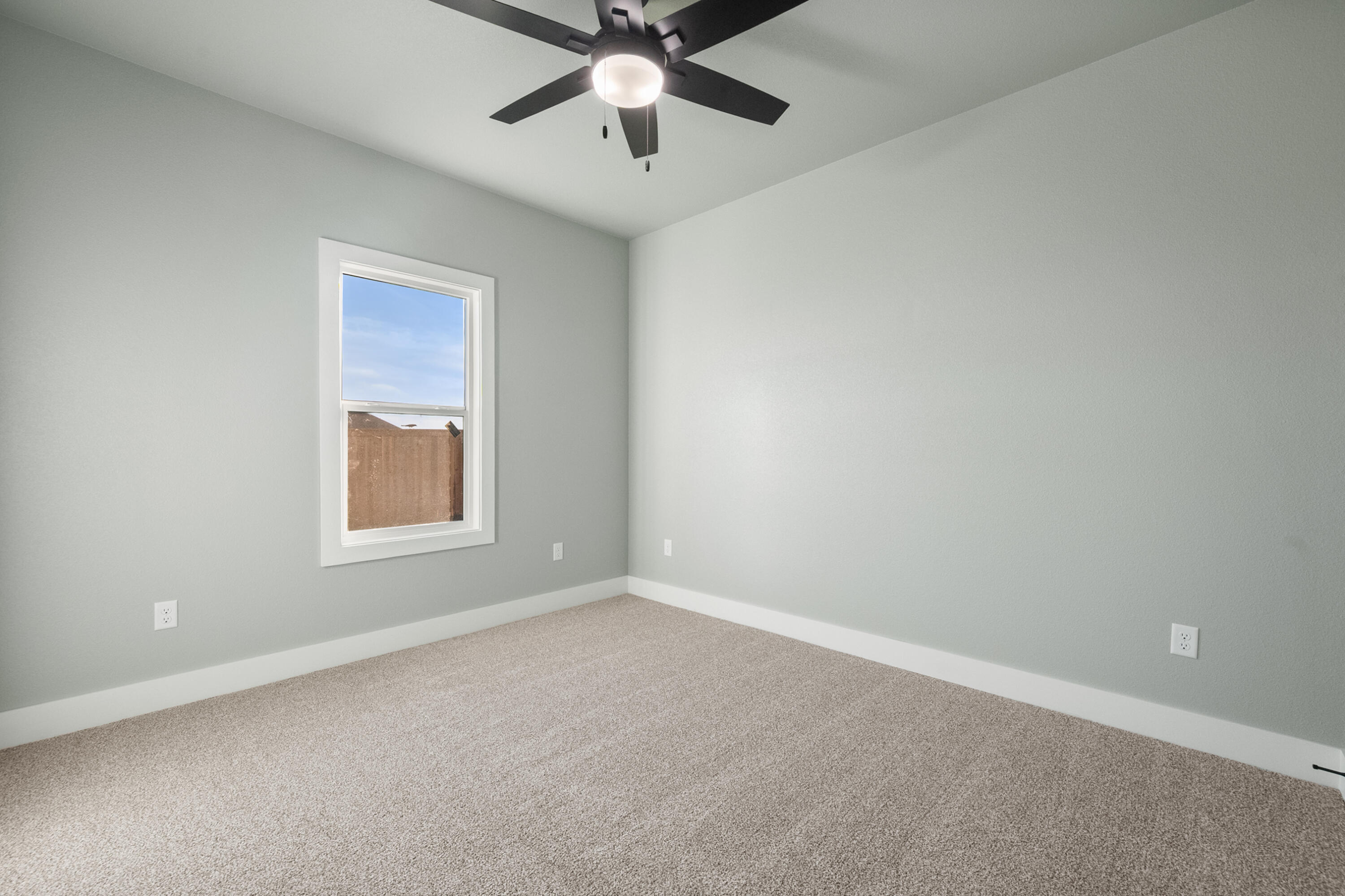 1121 North 6th Street Wolfforth, TX 79382 - Photo 26 of 31 an empty room with a window and a fan