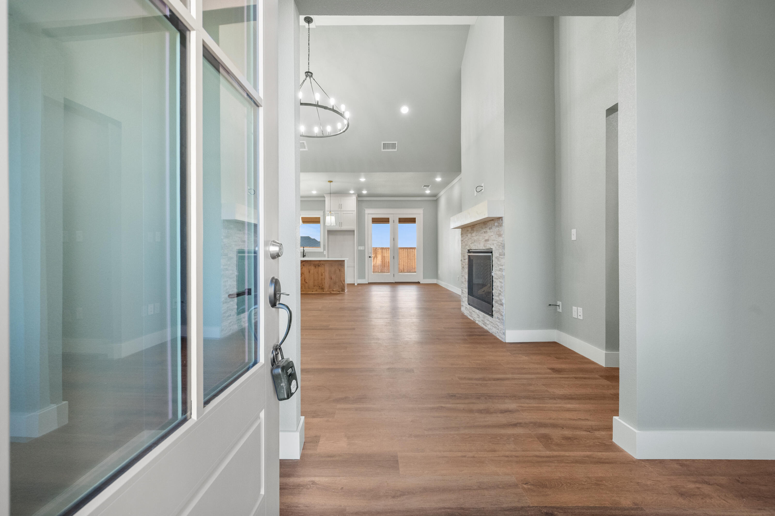 1121 North 6th Street Wolfforth, TX 79382 - Photo 4 of 31 a view of a hallway with wooden floor and a kitchen