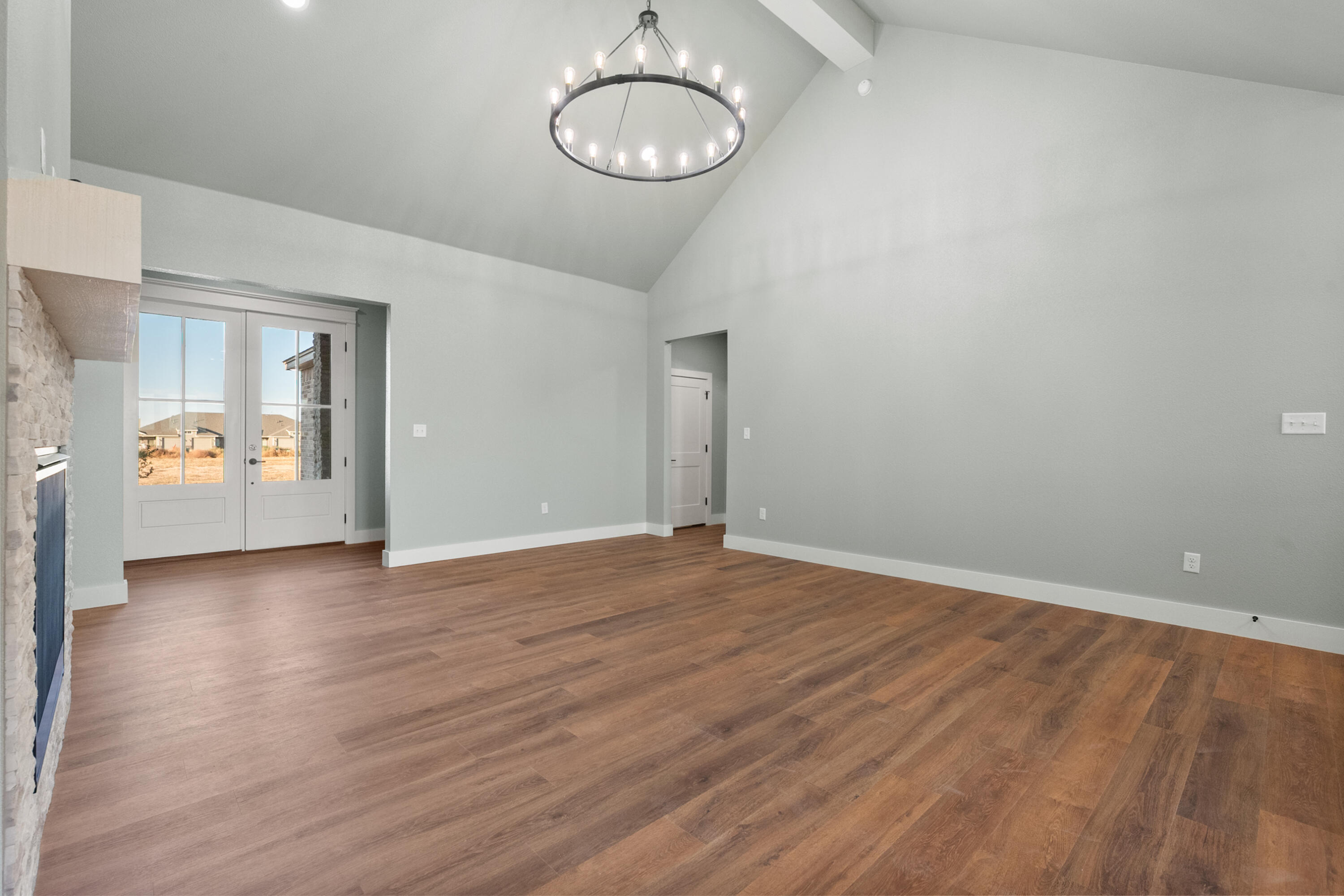1121 North 6th Street Wolfforth, TX 79382 - Photo 9 of 31 a view of an empty room with wooden floor and a large window