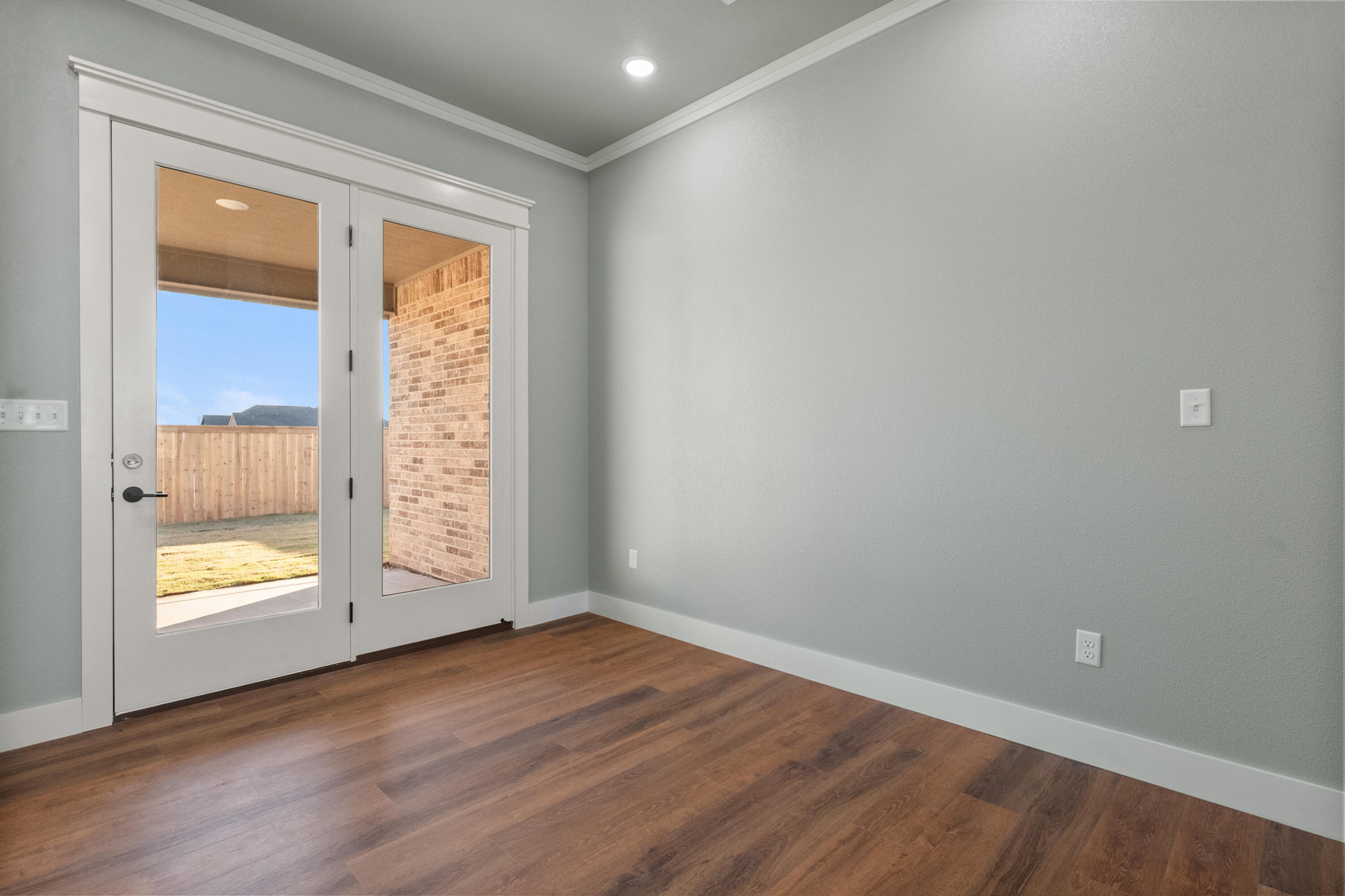 1121 North 6th Street Wolfforth, TX 79382 - Photo 10 of 31 an empty room with wooden floor and windows