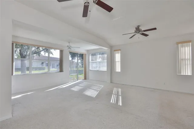 an aerial view of a house with outdoor space and lake view in back