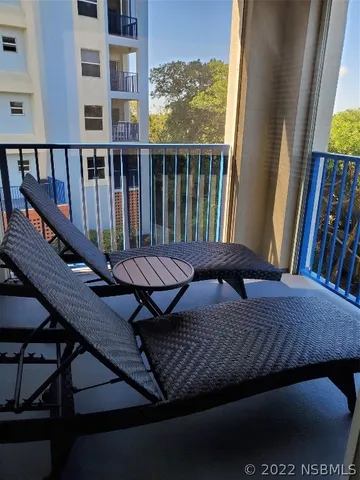 a view of a balcony with furniture