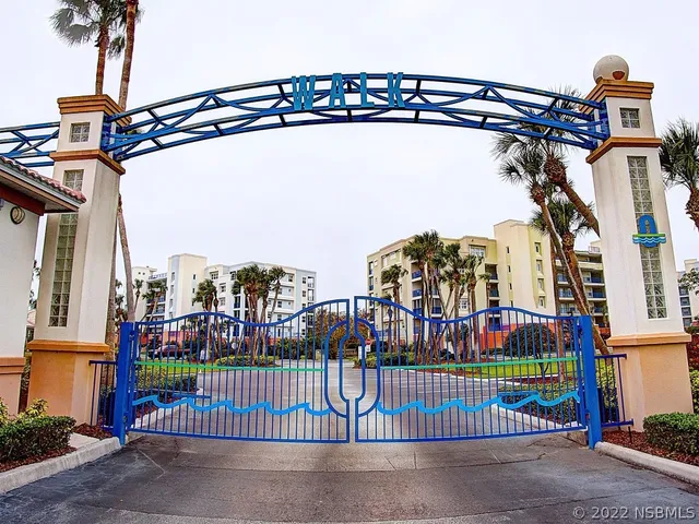 a view of a house with pool and sitting area