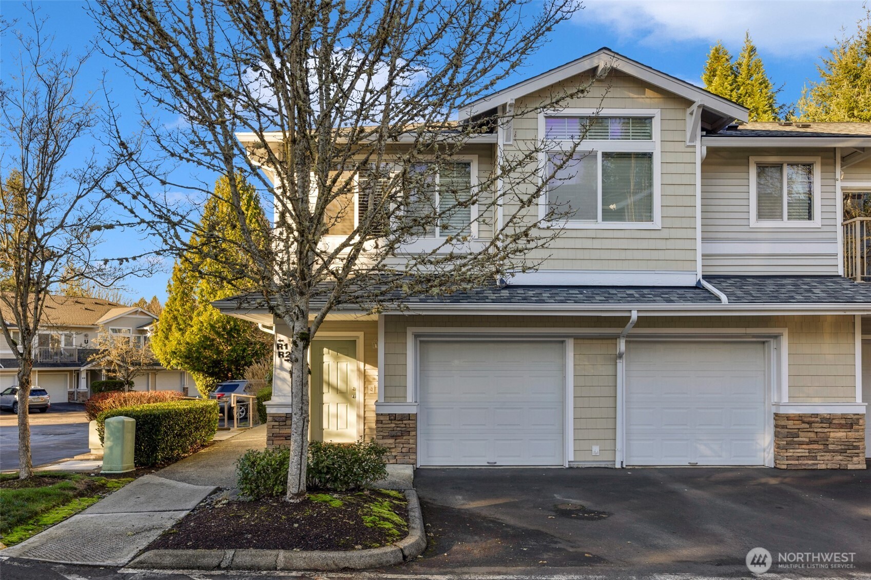 14007 69th Drive Southeast, Unit R2 Snohomish, WA 98296 - Photo 1 of 21 a front view of a house with garden