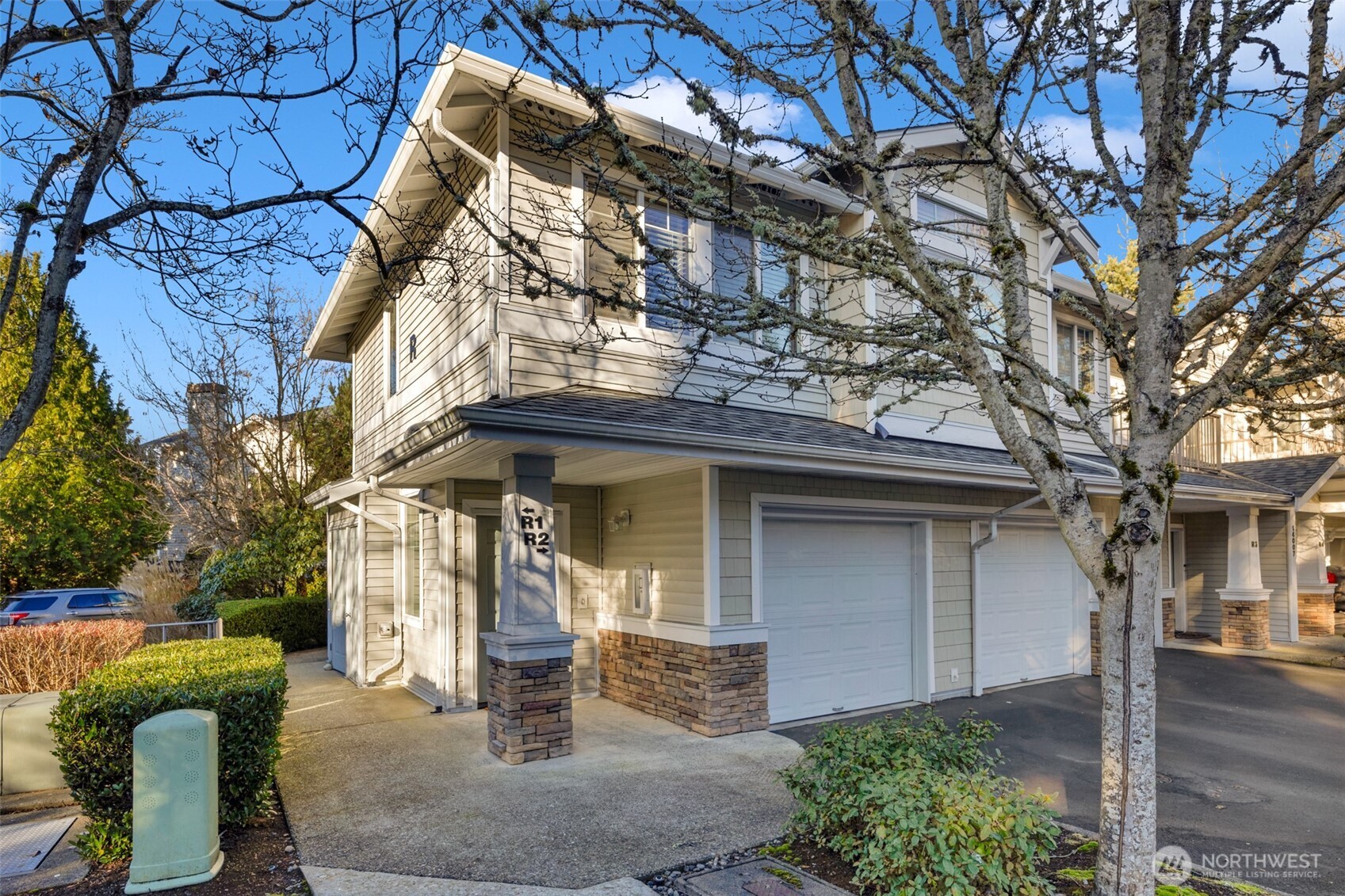 14007 69th Drive Southeast, Unit R2 Snohomish, WA 98296 - Photo 2 of 21 a front view of a house with garden