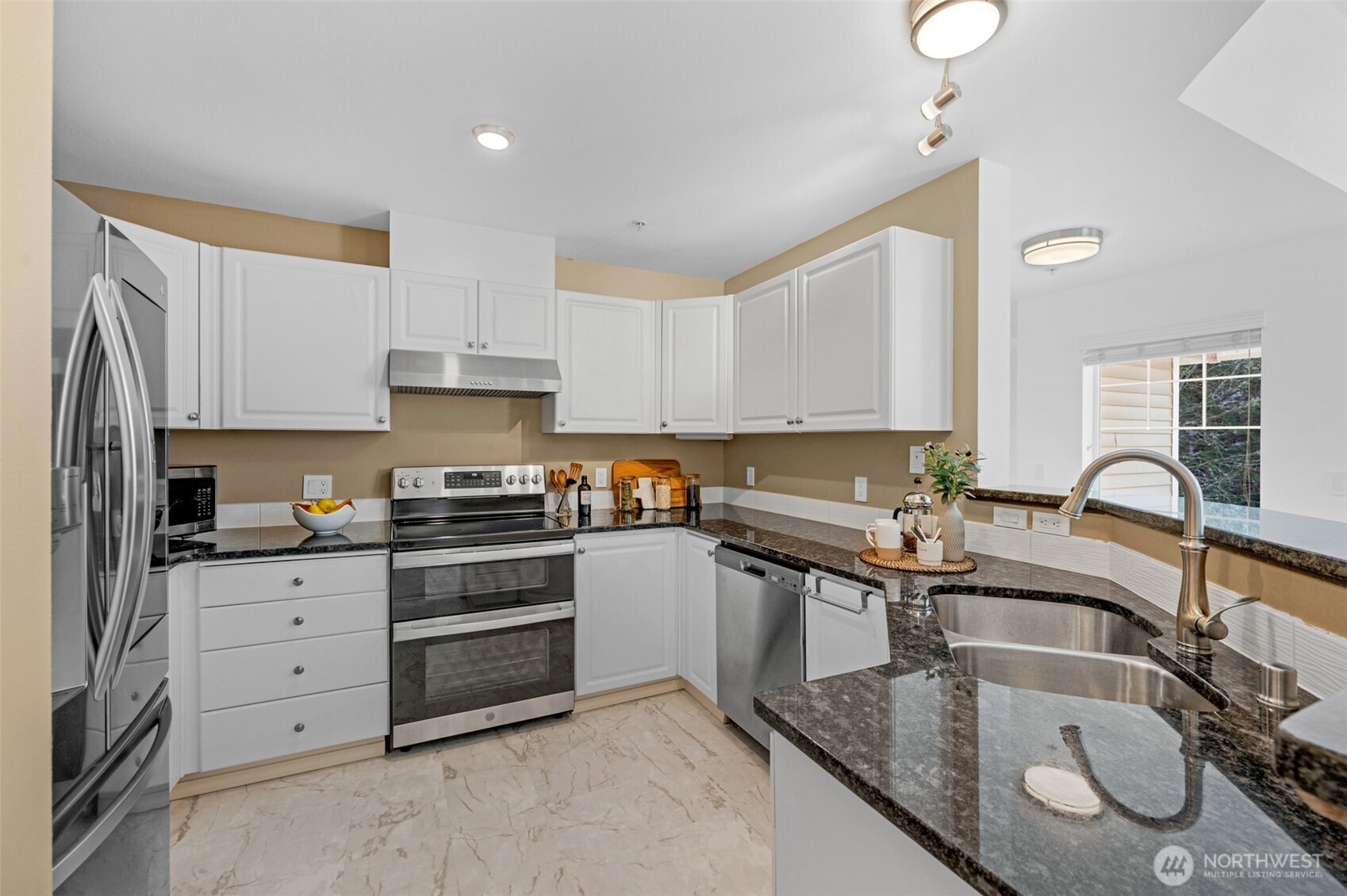 14007 69th Drive Southeast, Unit R2 Snohomish, WA 98296 - Photo 10 of 21 a kitchen with granite countertop a sink stainless steel appliances and cabinets