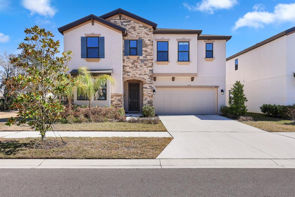 14671 Horse Trot Road Lithia, FL 33547 - Photo 1 of 40 a front view of a house with a yard and garage
