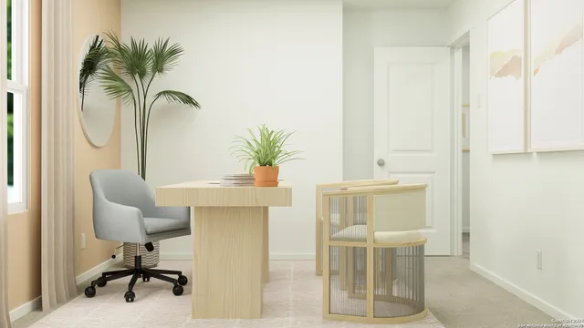 a dining room with furniture and a potted plant