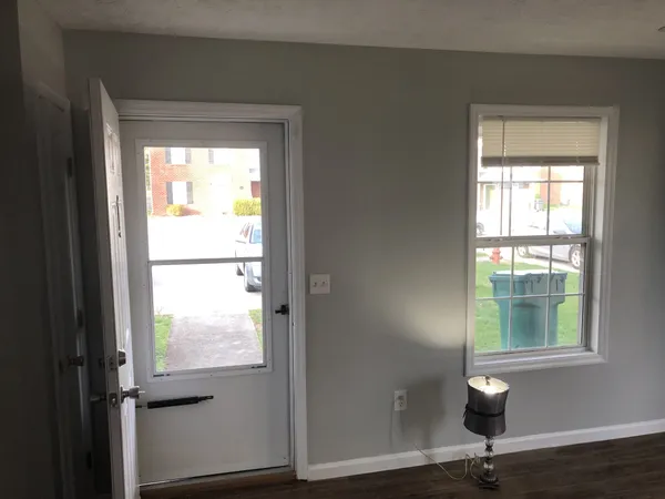 a view of an entryway with wooden floor