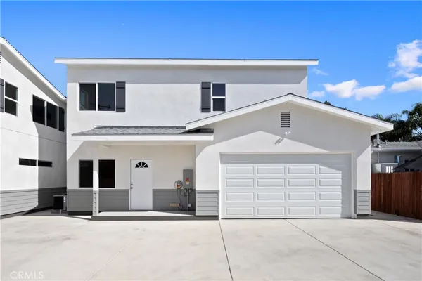 a front view of a house with garage