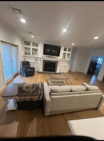 a view of a room with wooden floor