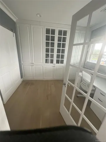 a spacious bedroom with a bed and a flat screen tv