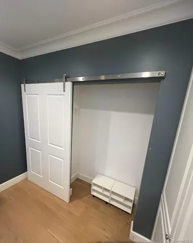 a bedroom with a large bed and a flat tv screen on dresser