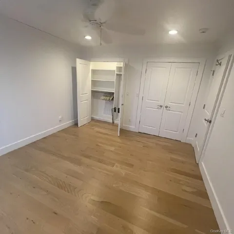 a view of closet with wooden floor and stairs