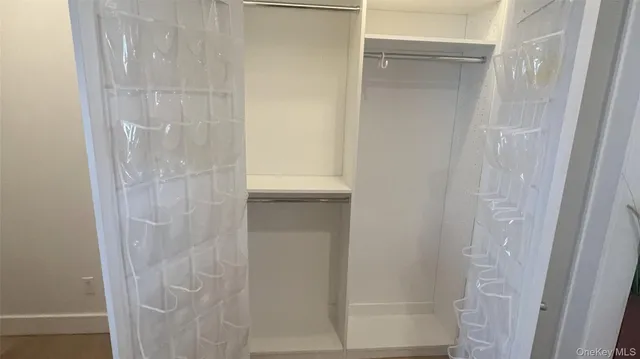 a large white kitchen with a stove a sink a refrigerator and chairs