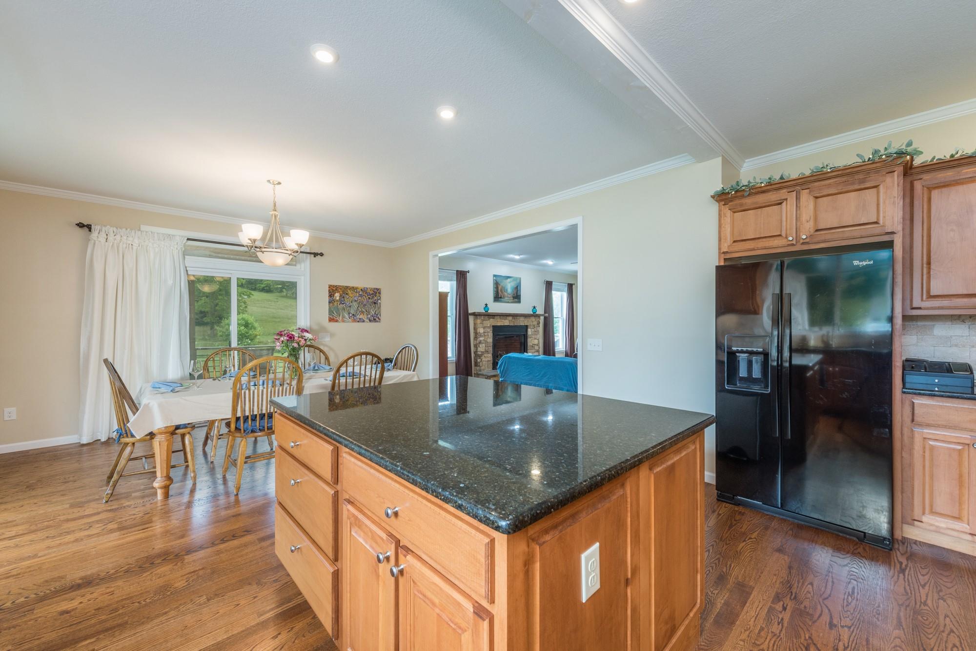 750 Iron Tree Drive Clyde, NC 28721 - Photo 19 of 40 a kitchen with stainless steel appliances granite countertop a kitchen island a table and chairs