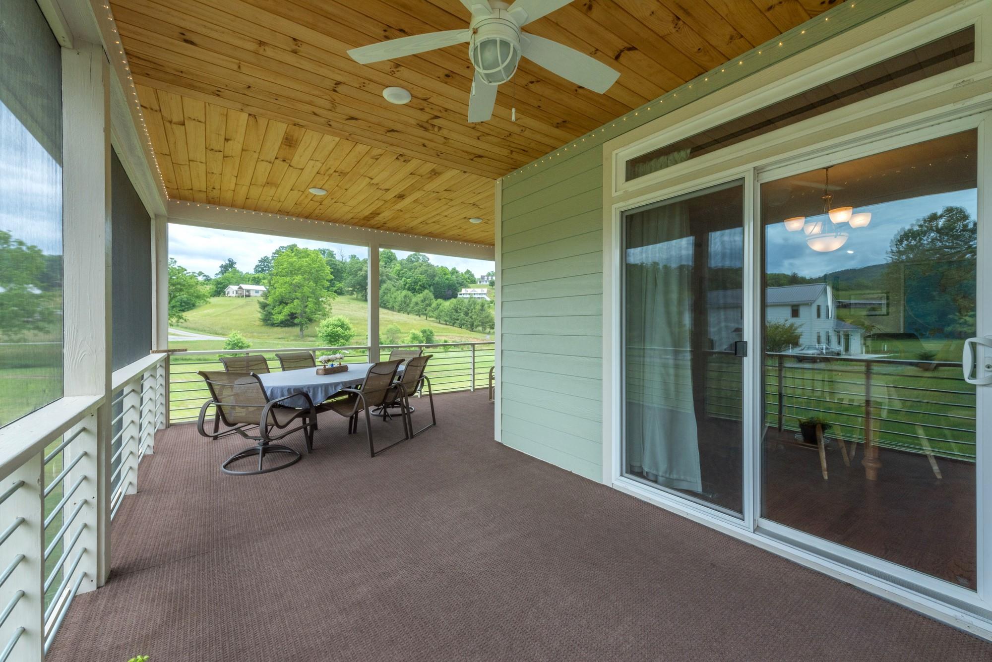 750 Iron Tree Drive Clyde, NC 28721 - Photo 20 of 40 a view of a porch with chairs and backyard