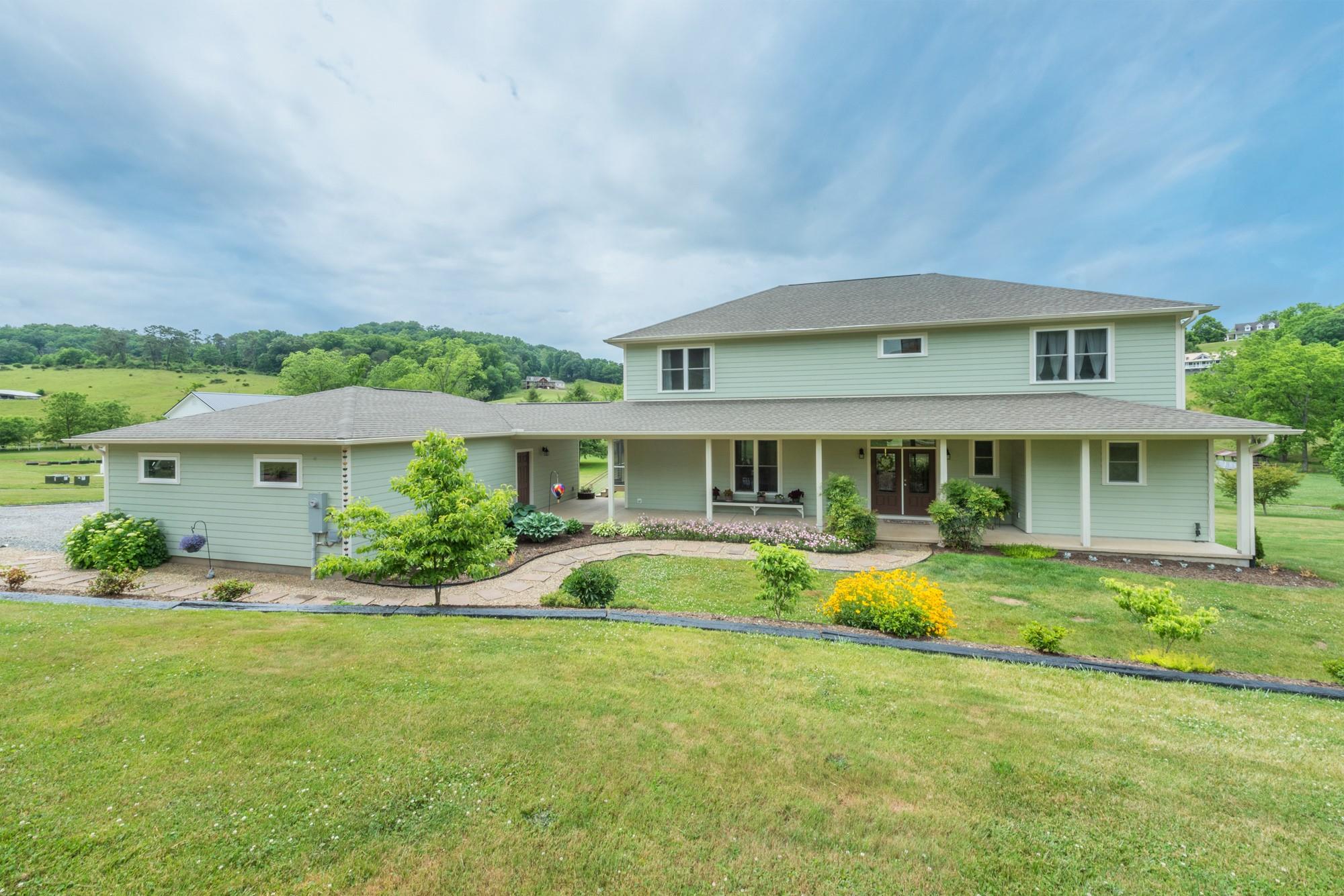 750 Iron Tree Drive Clyde, NC 28721 - Photo 2 of 40 a front view of a house with swimming pool having outdoor seating
