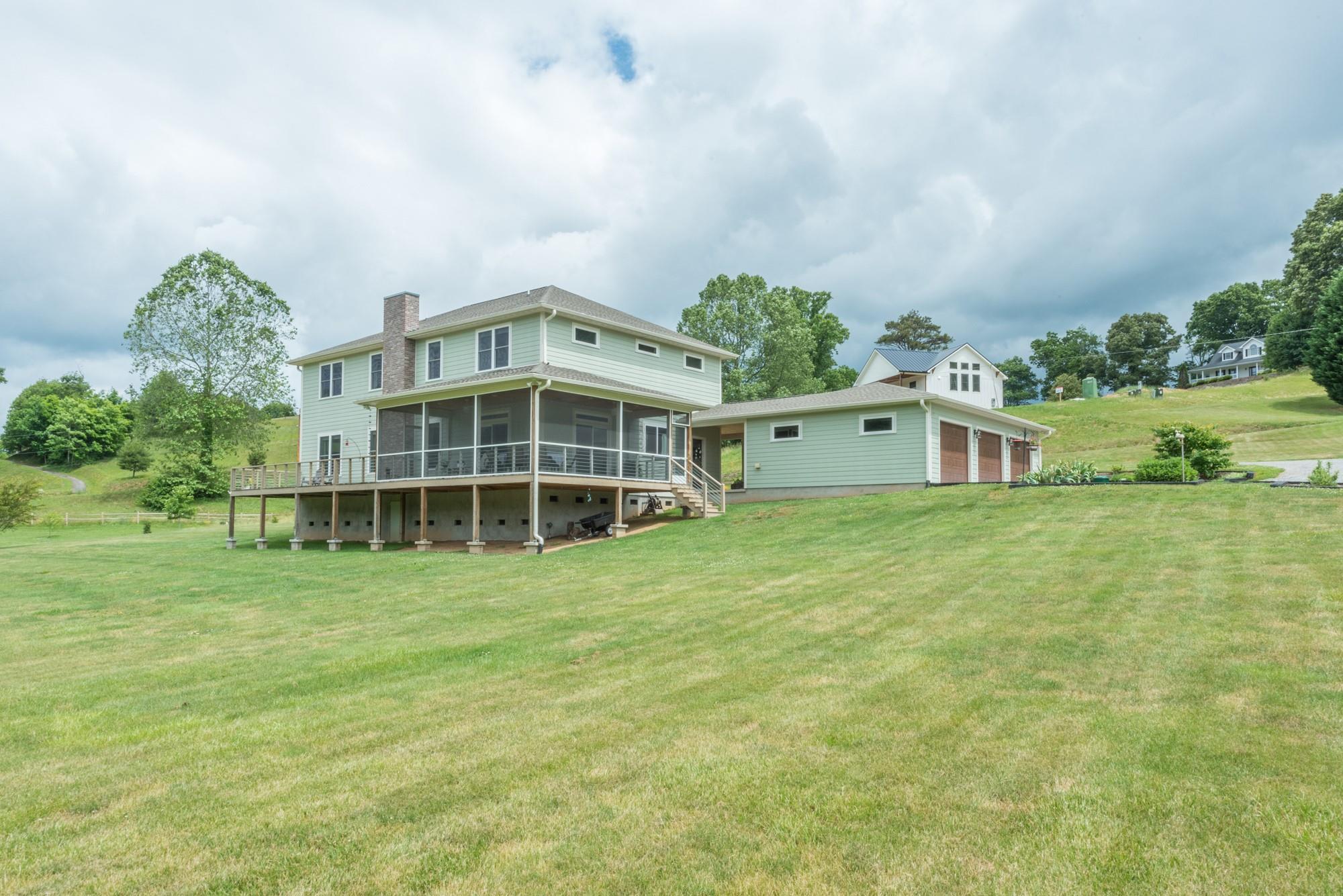 750 Iron Tree Drive Clyde, NC 28721 - Photo 26 of 40 a big white building with a big yard and large trees