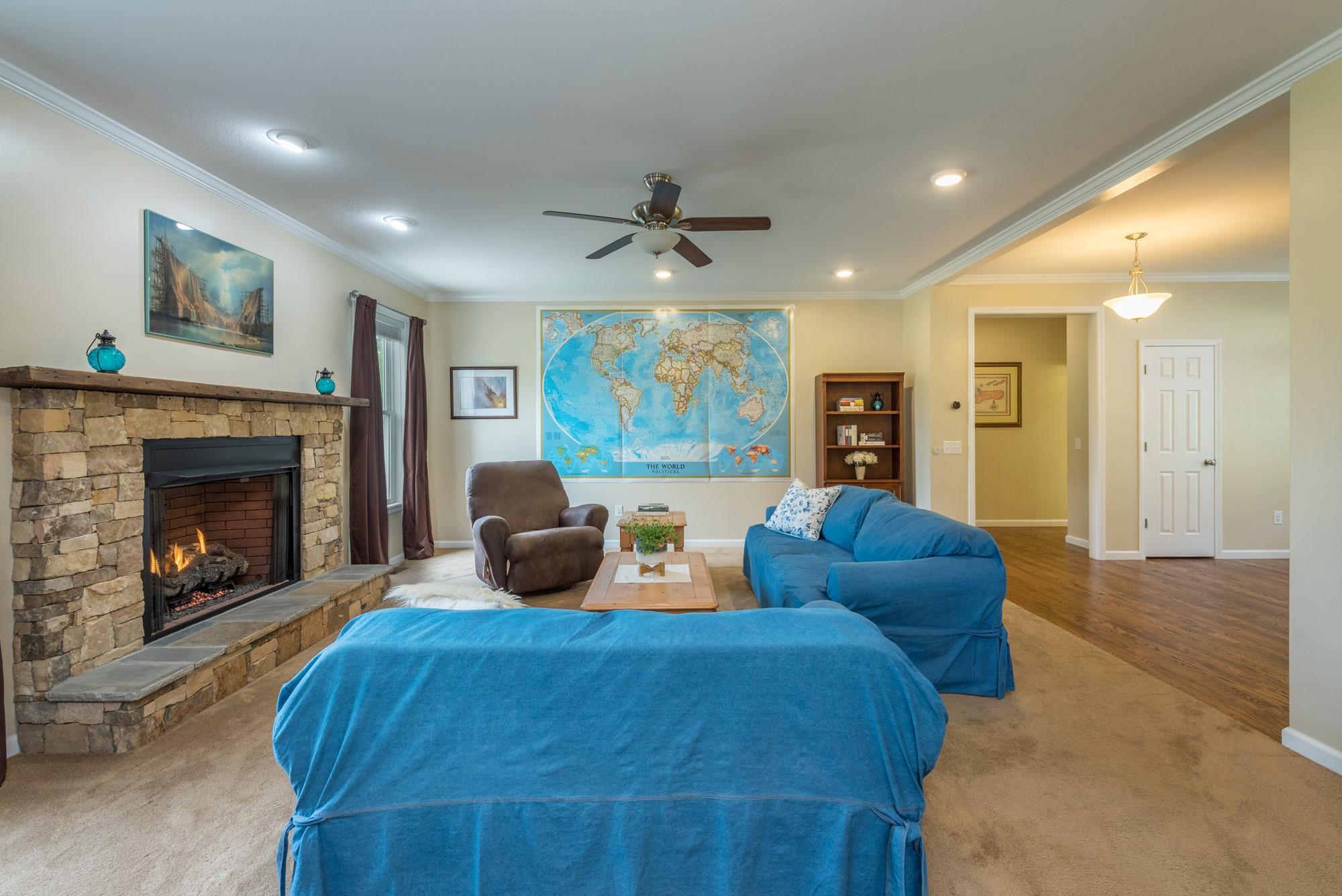 750 Iron Tree Drive Clyde, NC 28721 - Photo 28 of 40 a living room with furniture a fireplace and a large window