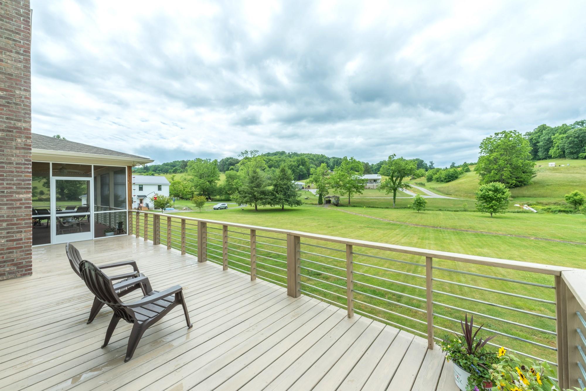 750 Iron Tree Drive Clyde, NC 28721 - Photo 37 of 40 a view of a terrace with wooden floor and fence