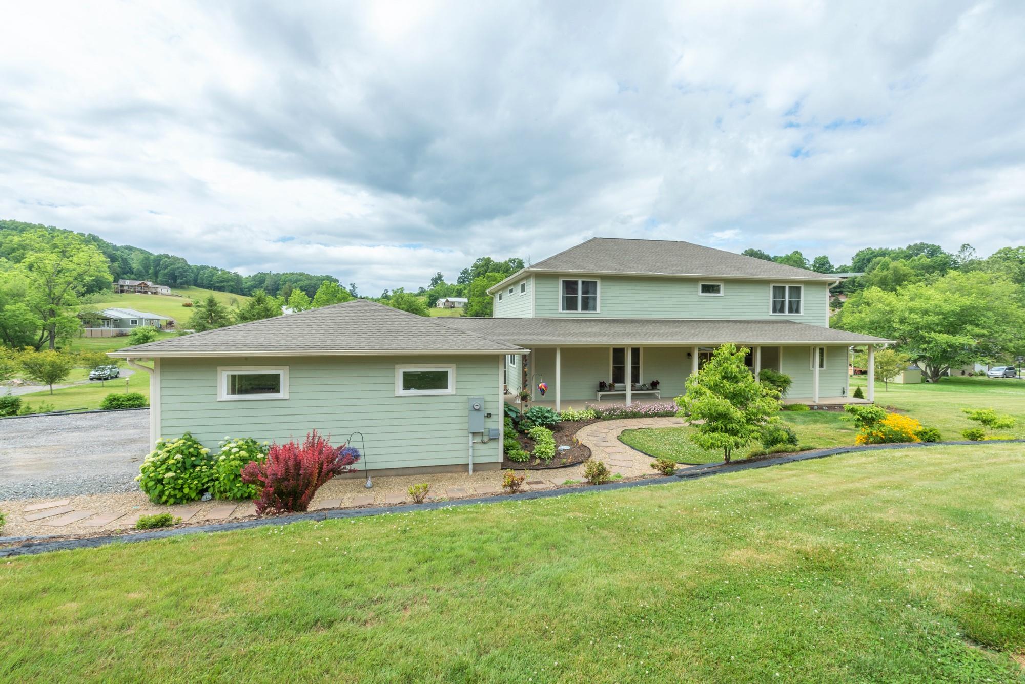 750 Iron Tree Drive Clyde, NC 28721 - Photo 38 of 40 a front view of a house with garden