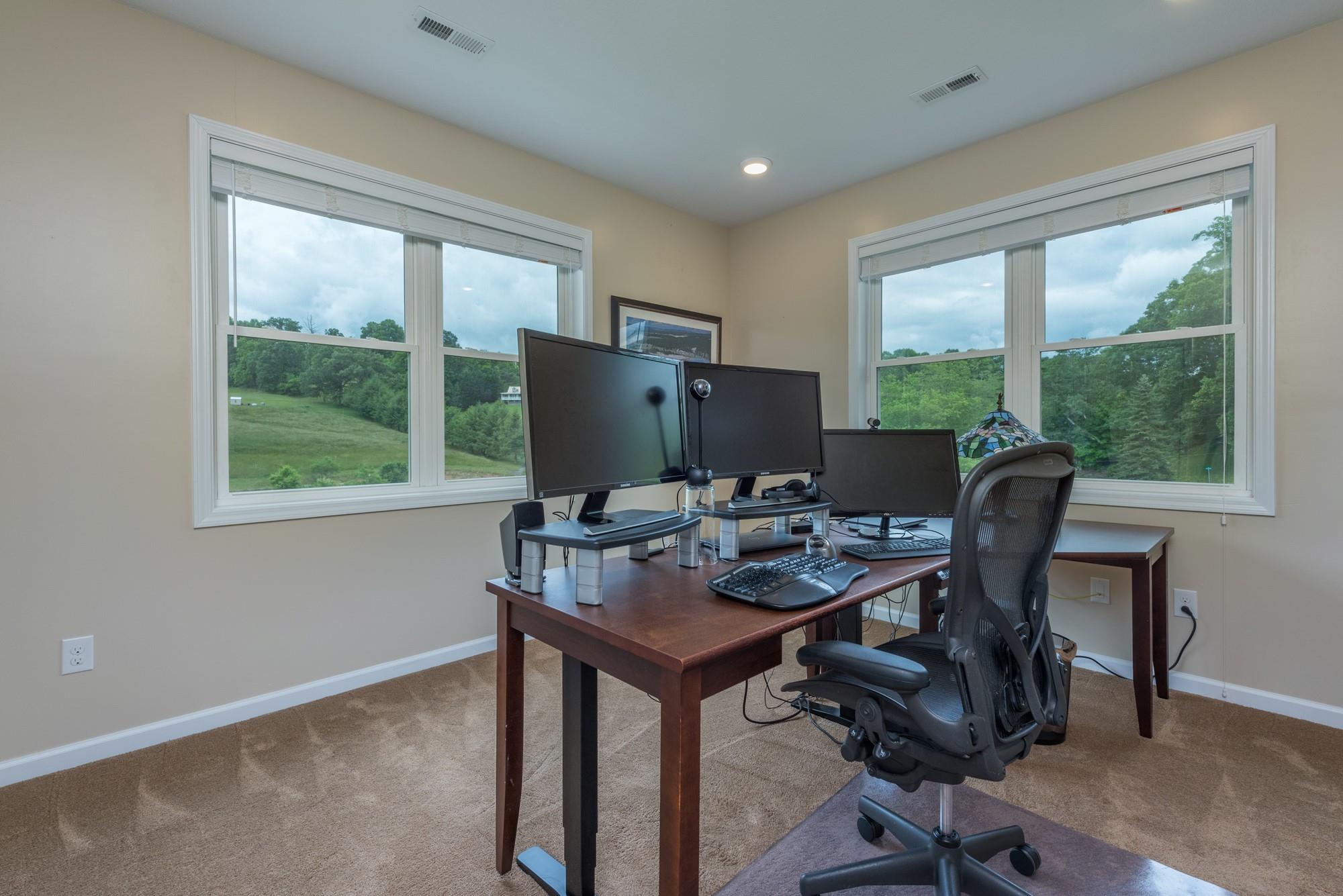 750 Iron Tree Drive Clyde, NC 28721 - Photo 6 of 40 a view of a workspace with furniture and a window