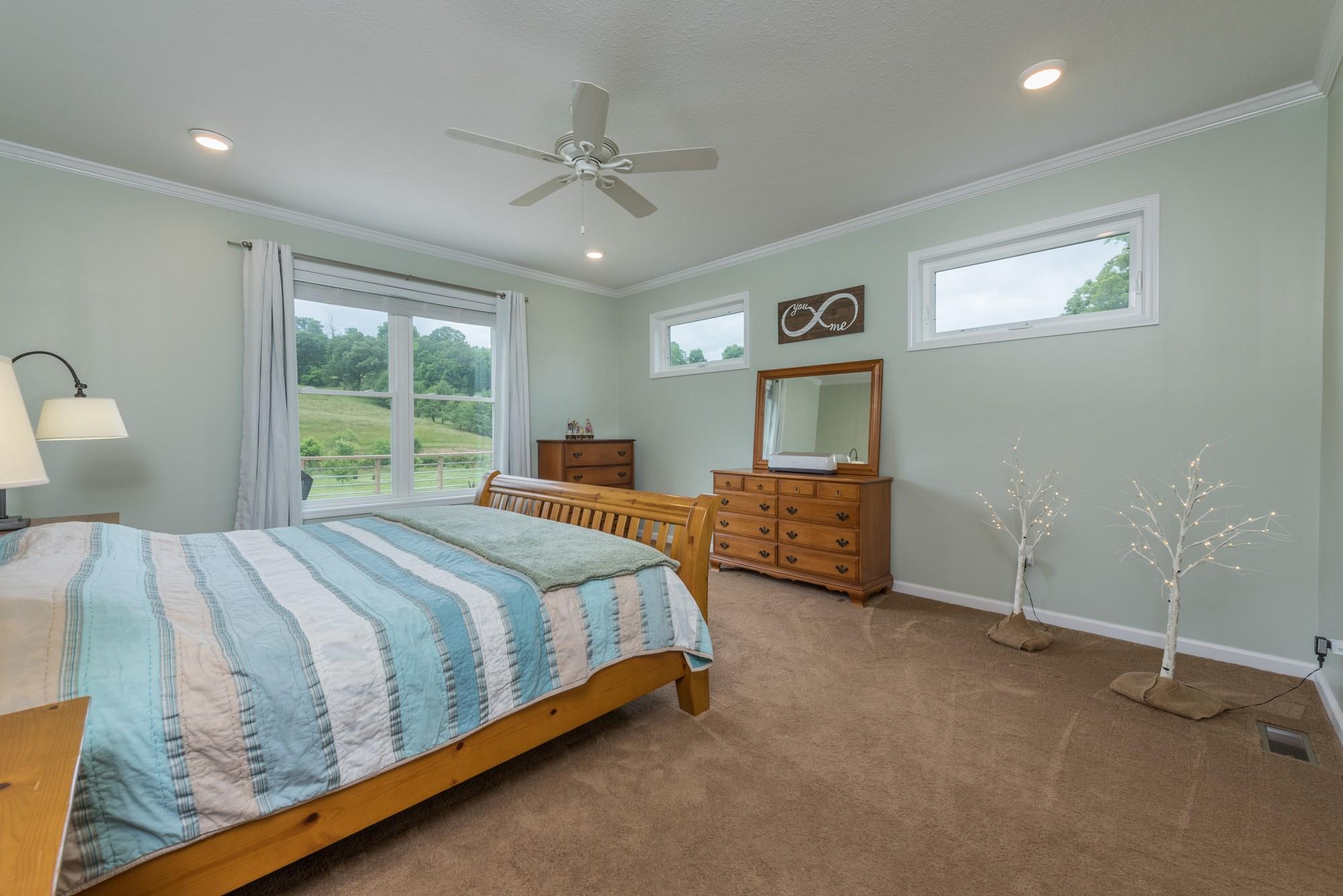 750 Iron Tree Drive Clyde, NC 28721 - Photo 8 of 40 a bedroom with a bed and a night stand