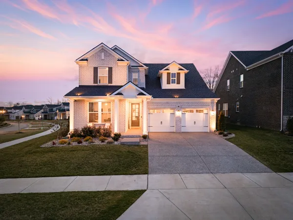 a front view of a house with a yard