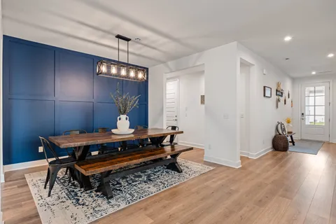 a living room with a couch and a chandelier