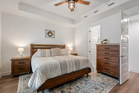 a bedroom with a bed and a chandelier