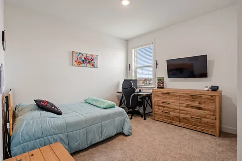 a bedroom with a bed and a flat screen tv