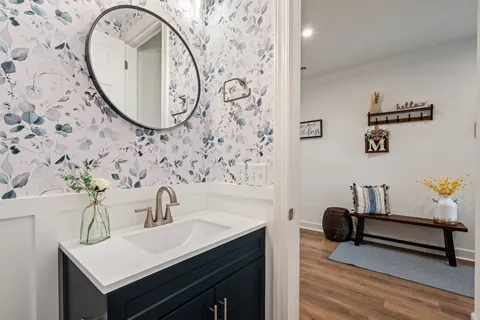 a bathroom with a sink mirror and vanity