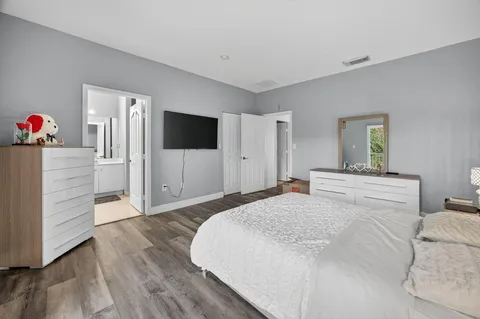 a bedroom with a bed and a flat screen tv