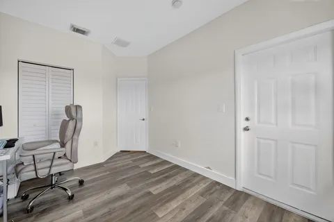 a view of workspace with wooden floor windows