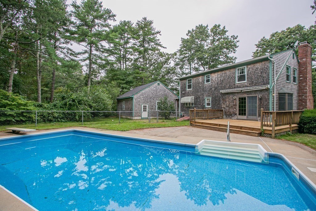a view of a house with swimming pool and sitting area