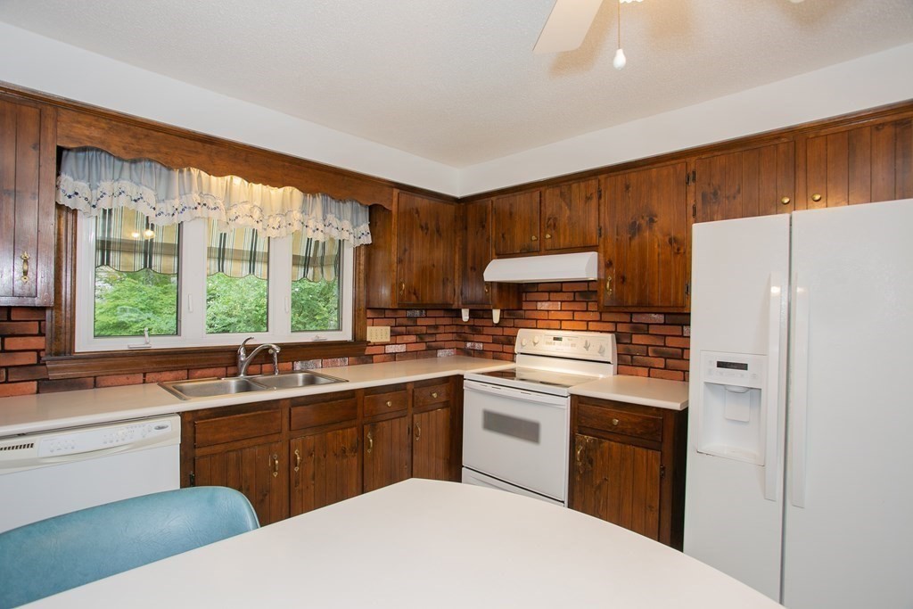 36 Morton Road Freetown, MA 02717 - Photo 17 of 40 a kitchen with a sink a stove a refrigerator and cabinets