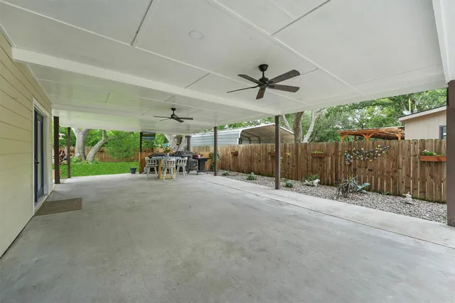 a view of a patio with table and chairs