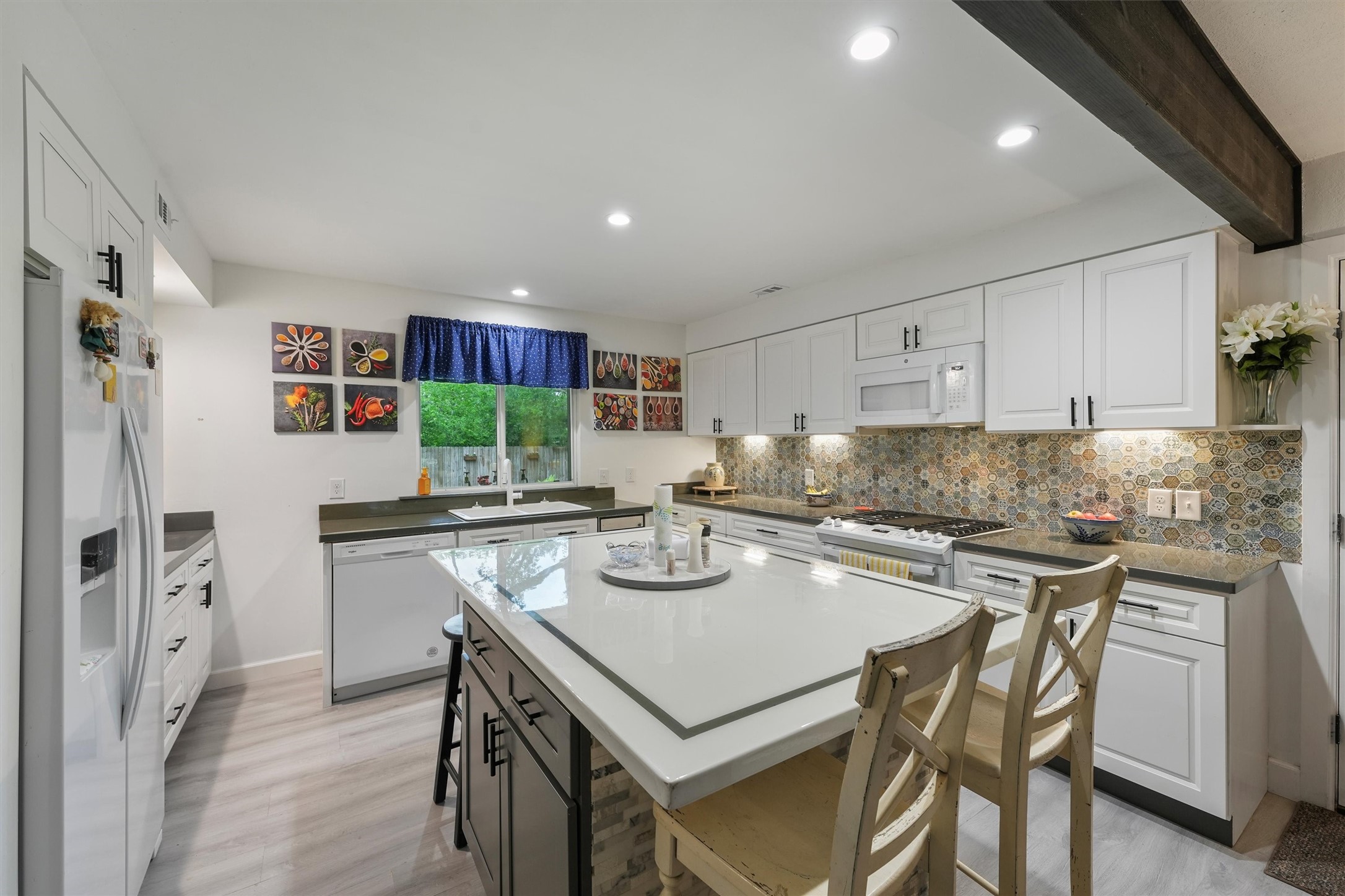 35 Bounty Palacios, TX 77465 - Photo 14 of 35 a kitchen with stainless steel appliances granite countertop a stove a refrigerator a sink a dining table and chairs