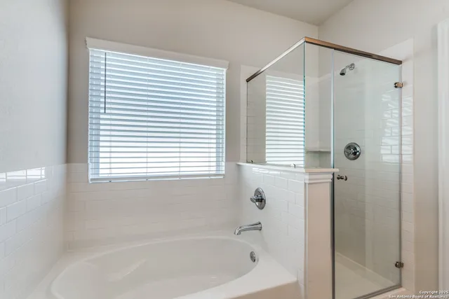 a bathroom with a bathtub and a shower