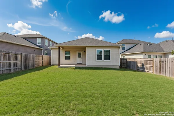 a view of house with backyard and garage