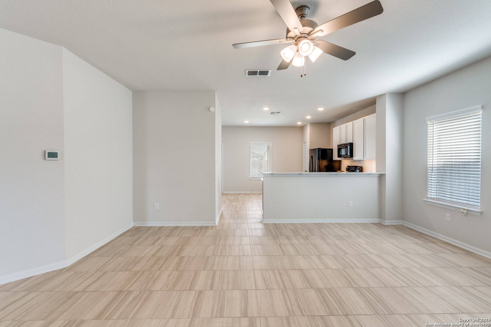 8931 Hazel Birch Elmendorf, TX 78112 - Photo 4 of 21 a view of a kitchen with a dishwasher cabinets and wooden floor