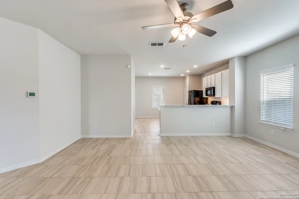 a view of a kitchen with a dishwasher cabinets and wooden floor