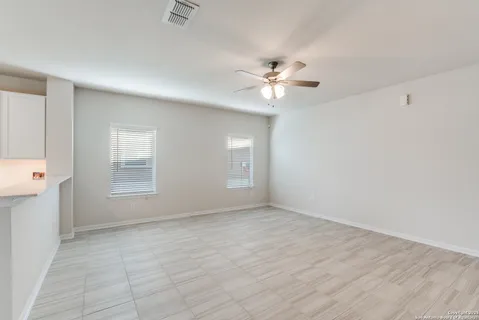 a kitchen with a sink a refrigerator and cabinets