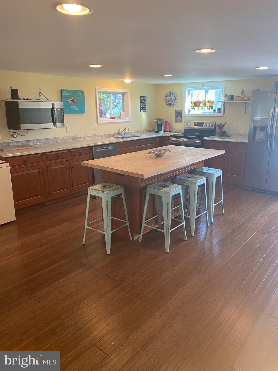 20805 Severn Road Ewell, MD 21824 - Photo 11 of 27 a kitchen with stainless steel appliances granite countertop a white cabinets and wooden floor