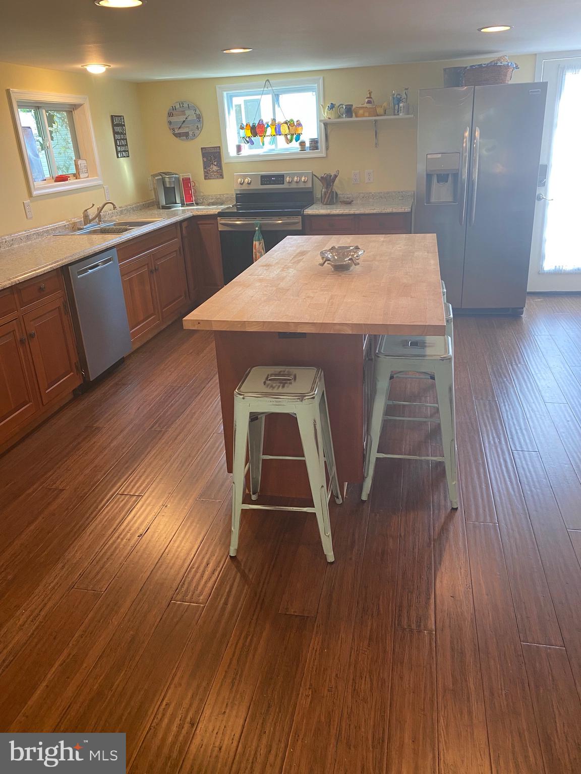 20805 Severn Road Ewell, MD 21824 - Photo 12 of 27 a kitchen with kitchen island sink stove and wooden floor