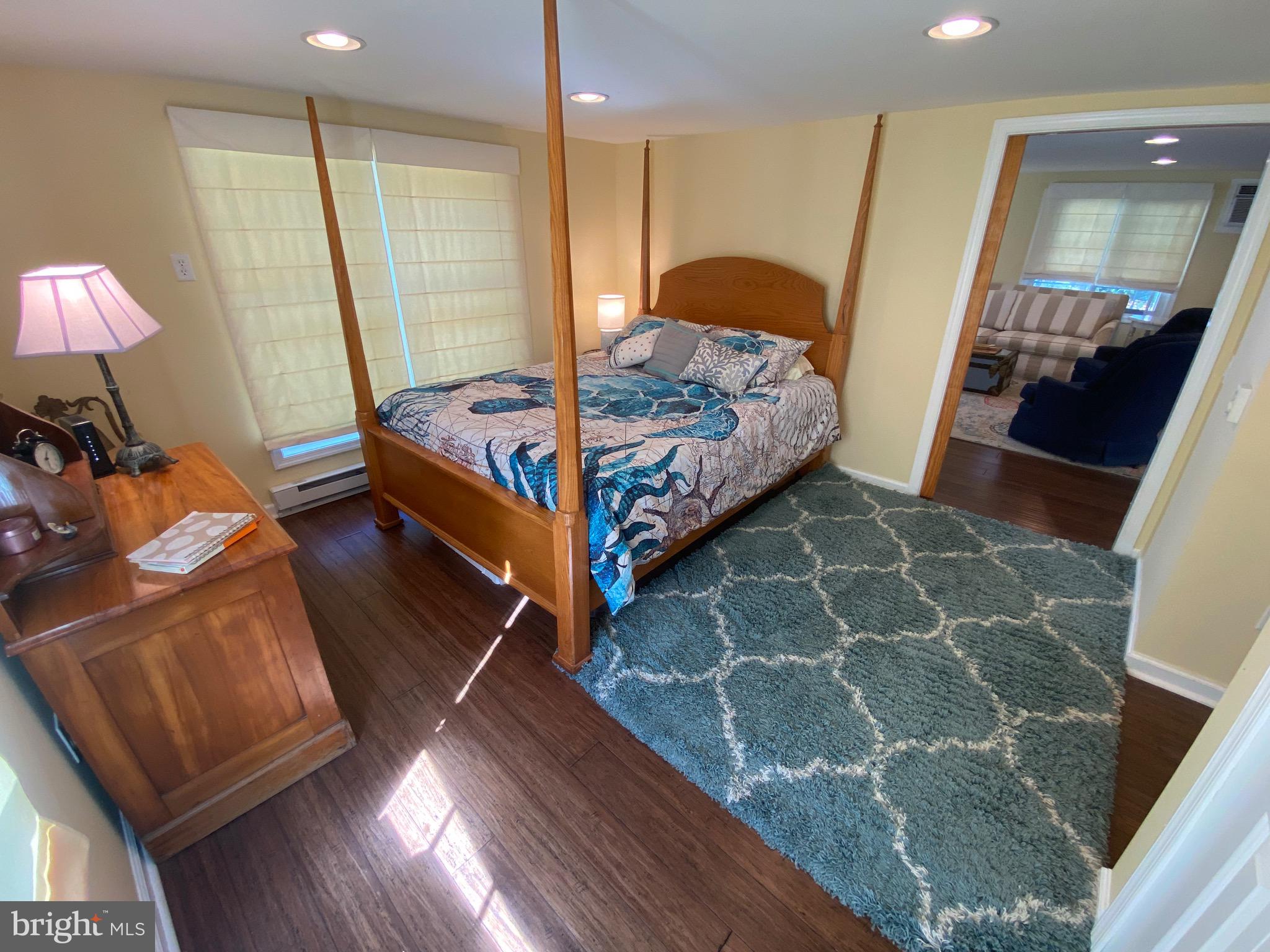 20805 Severn Road Ewell, MD 21824 - Photo 19 of 27 a bedroom with a bed and a mirror